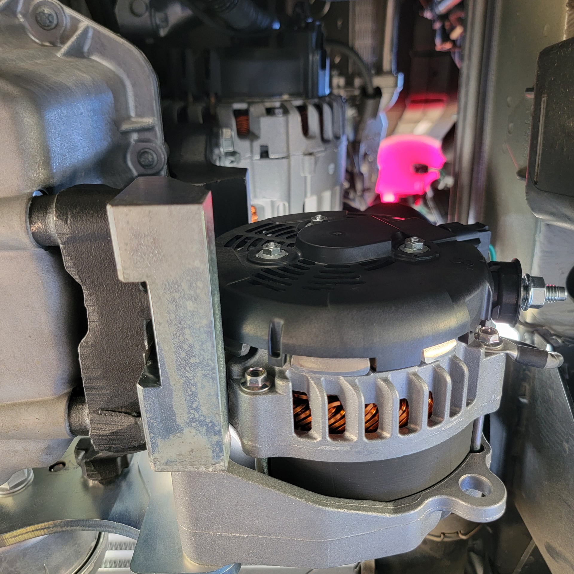 Mounted dual alternator in Sprinter van, showcasing the alternator and bracket assembly